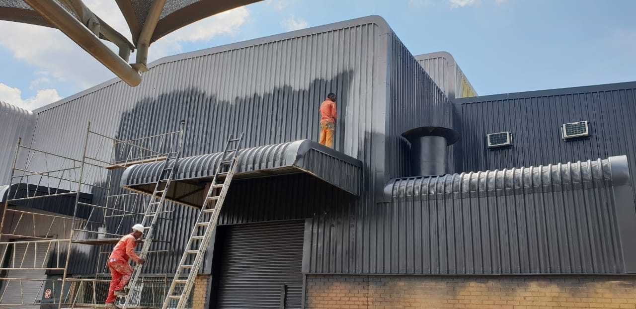 Building cladding cleaned and coated